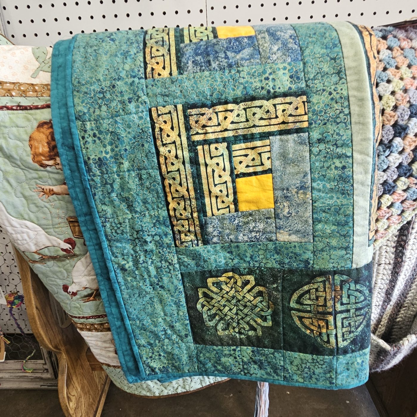 Wall of hand-stitched quilts on display